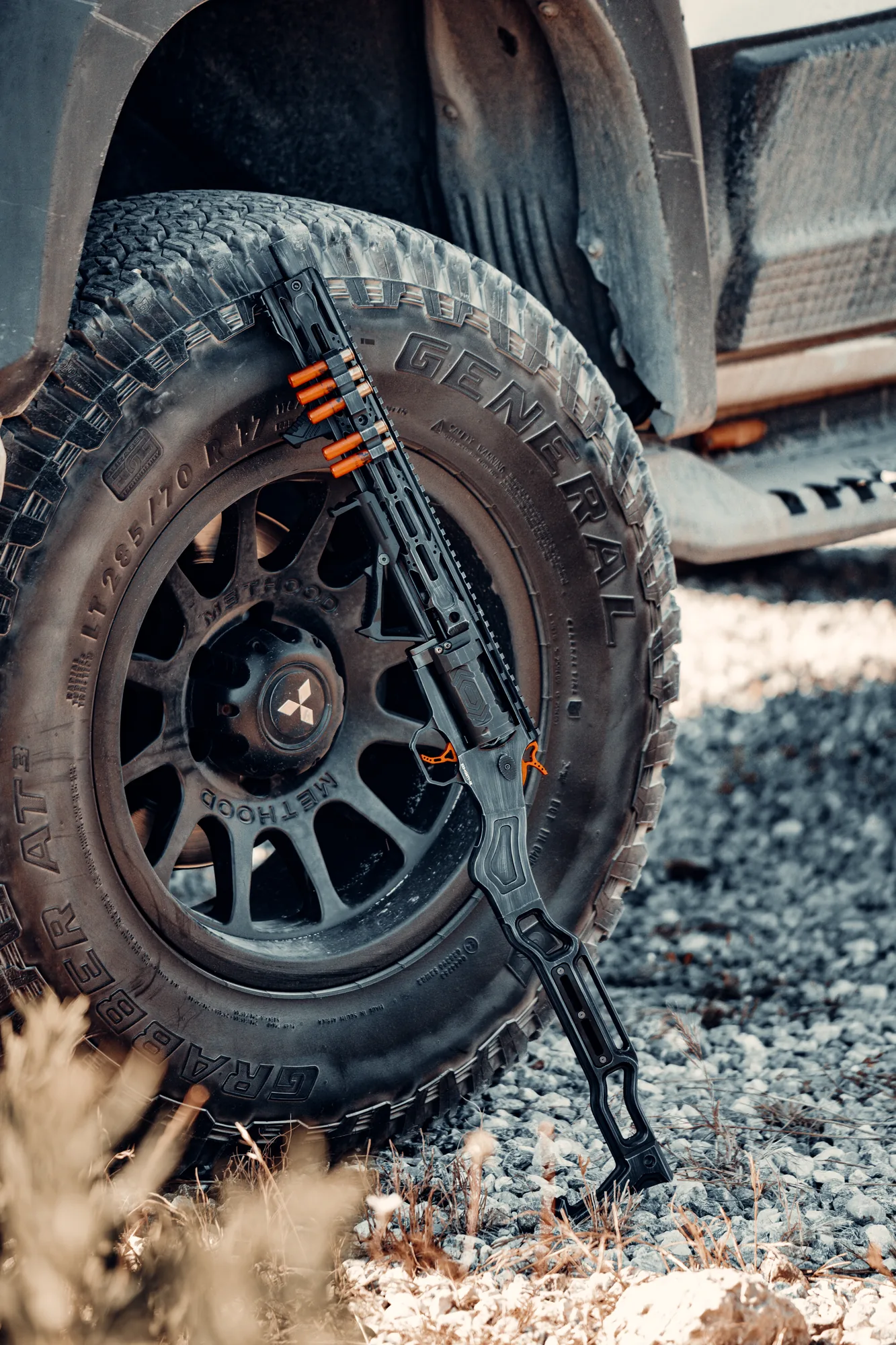 A TR410 leaning against the wheel of a pickup