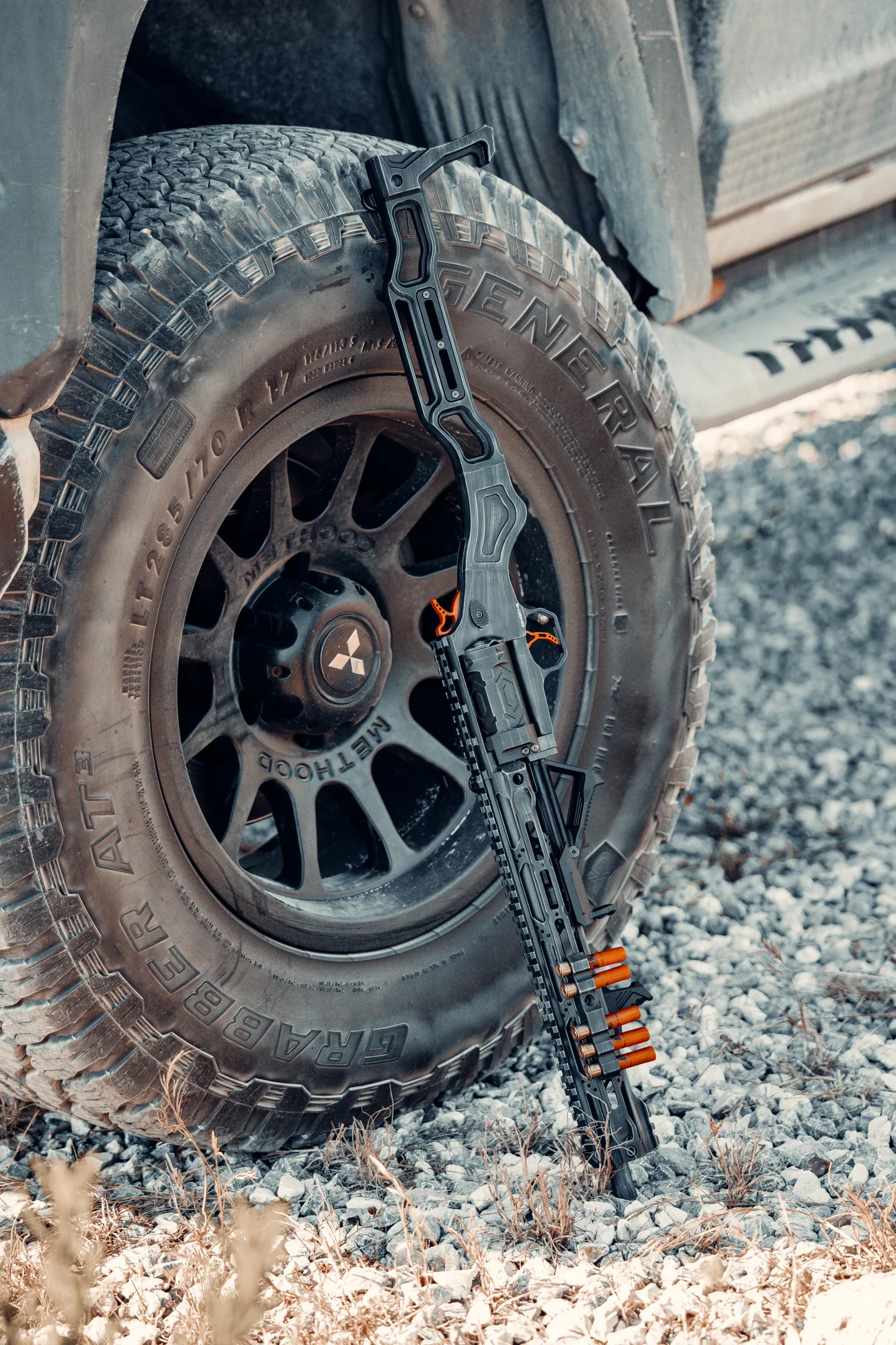 A TR410 standing in the gravel beside a wheel