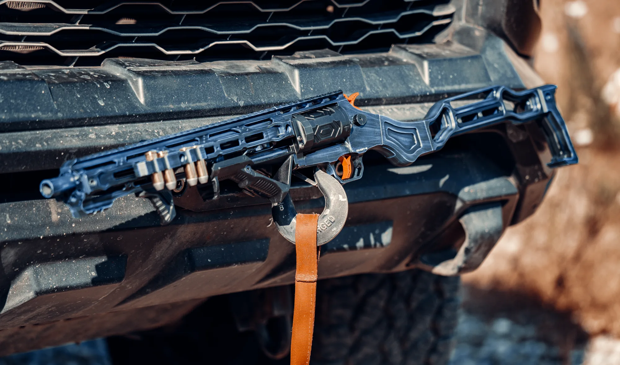 A TR410 laid across a pickup's front bumper